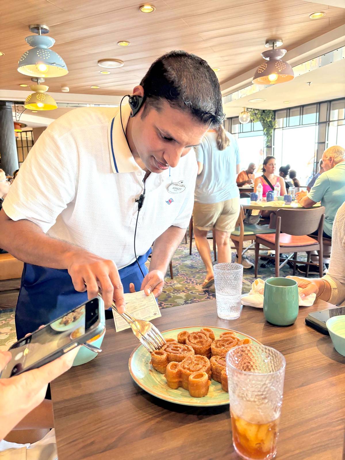 Our dining captain throughout the duration of our cruise makes sure we get to try a rare treat before we end our trip — the Mickey Waffle Churros.